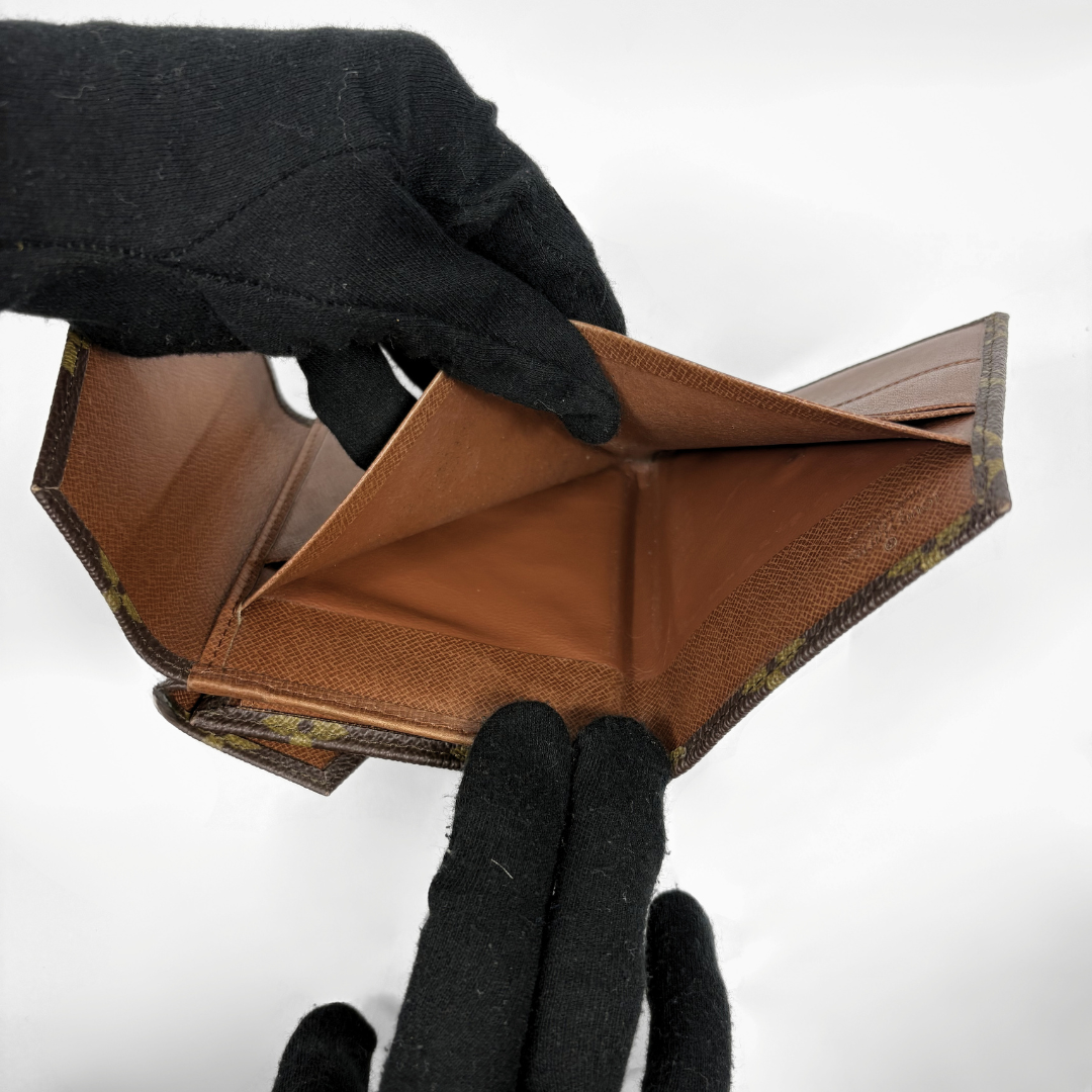 Louis Vuitton Druk Wallet on a white background