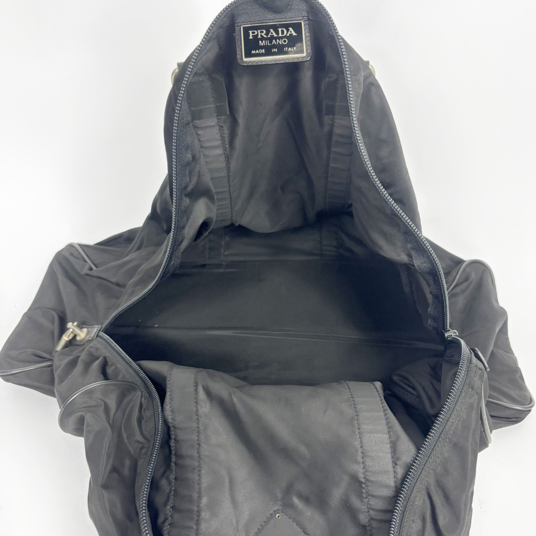 Black backpack with a strap and lock on a white background