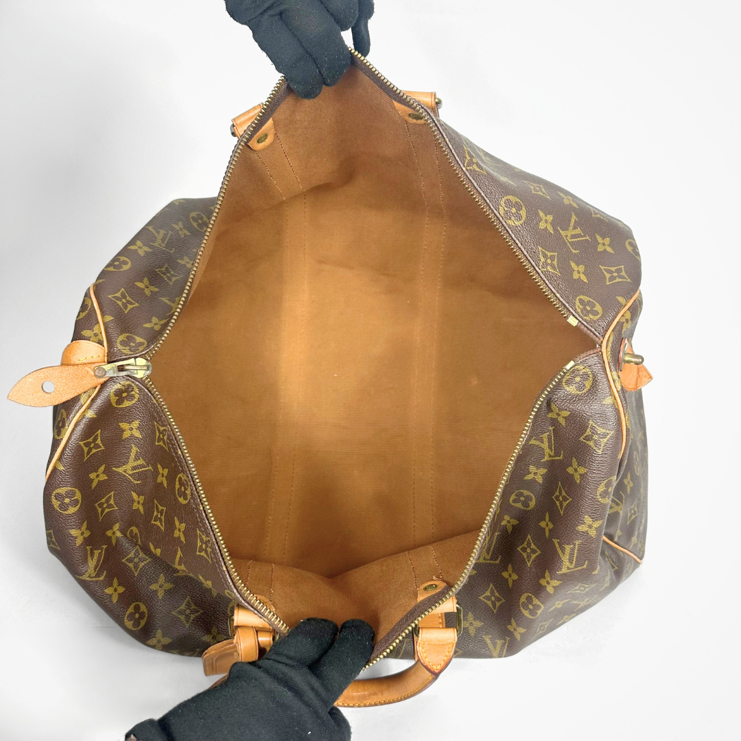 Designer handbag with monogram pattern on a white background