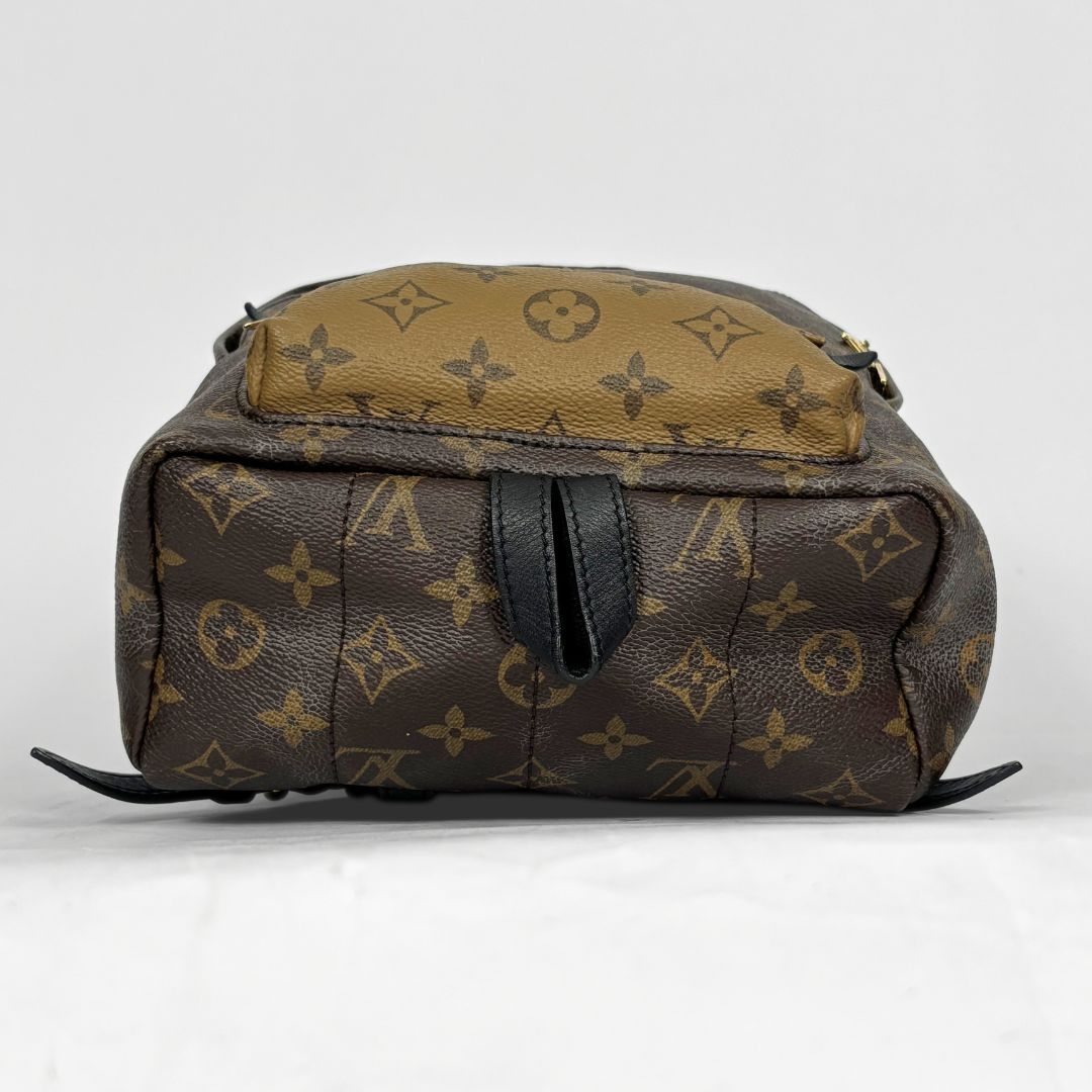Louis Vuitton backpack with monogram pattern on a white background