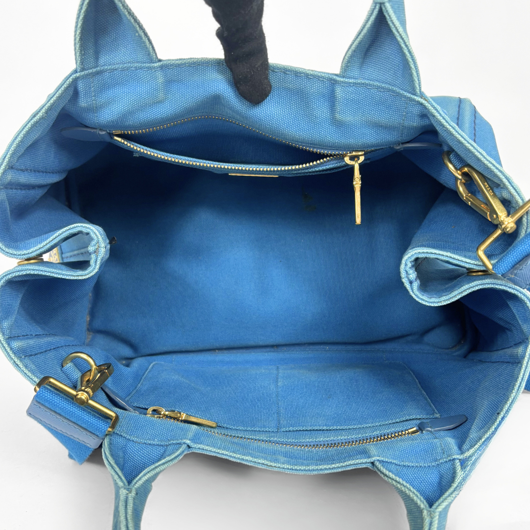 Blue Prada handbag on a white background