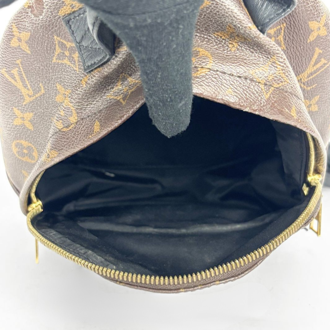 Louis Vuitton backpack with monogram pattern on a white background