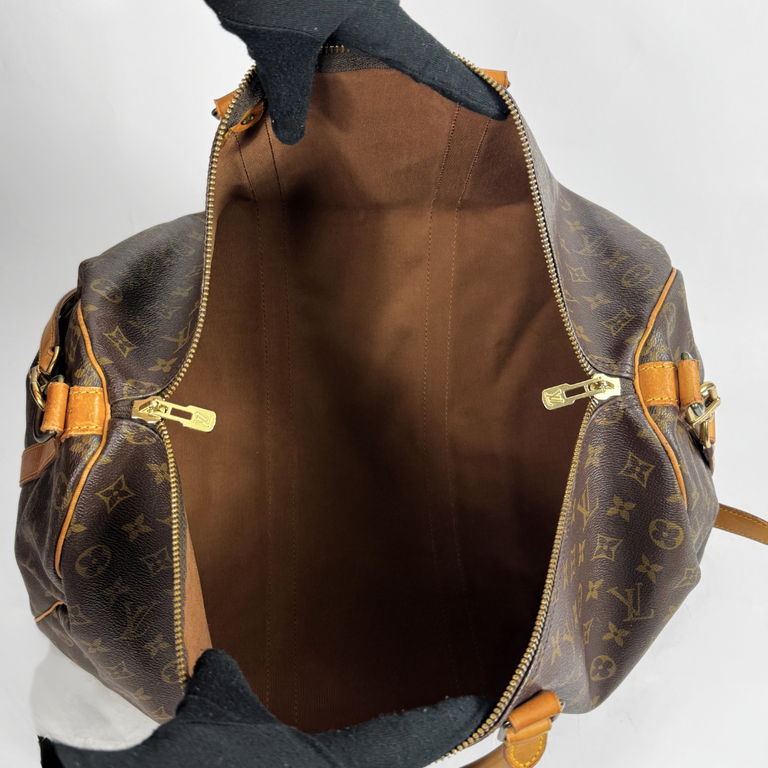 Louis Vuitton Keepall 50 with strap on a white background