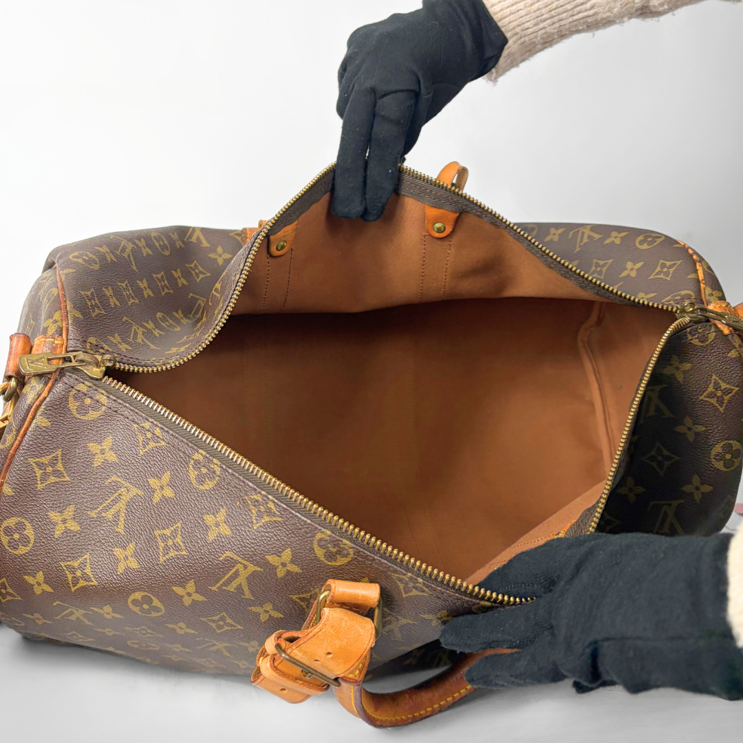 Brown duffel bag with monogram pattern on a white background