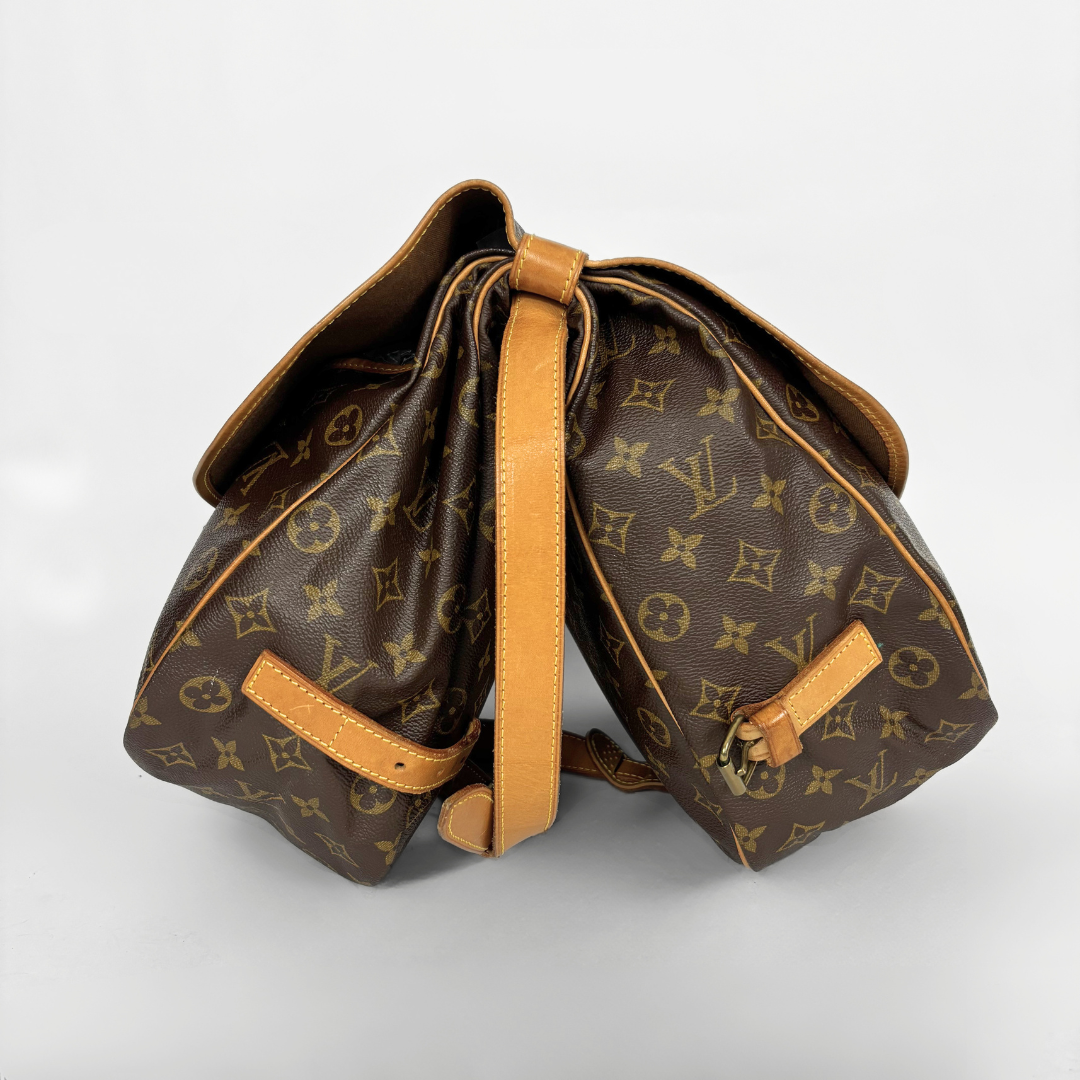 Brown monogrammed bag with tan leather accents on a light gray background