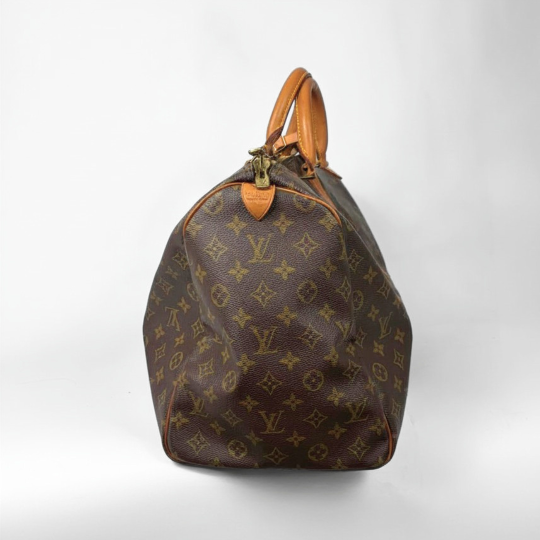Brown hand bag with orange accents and a prominent logo pattern on a white background