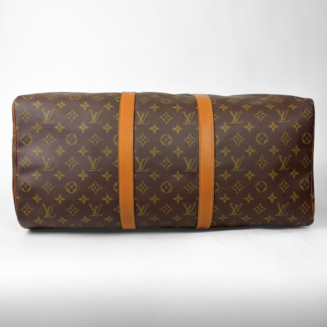 Brown hand bag with orange accents and a prominent logo pattern on a white background