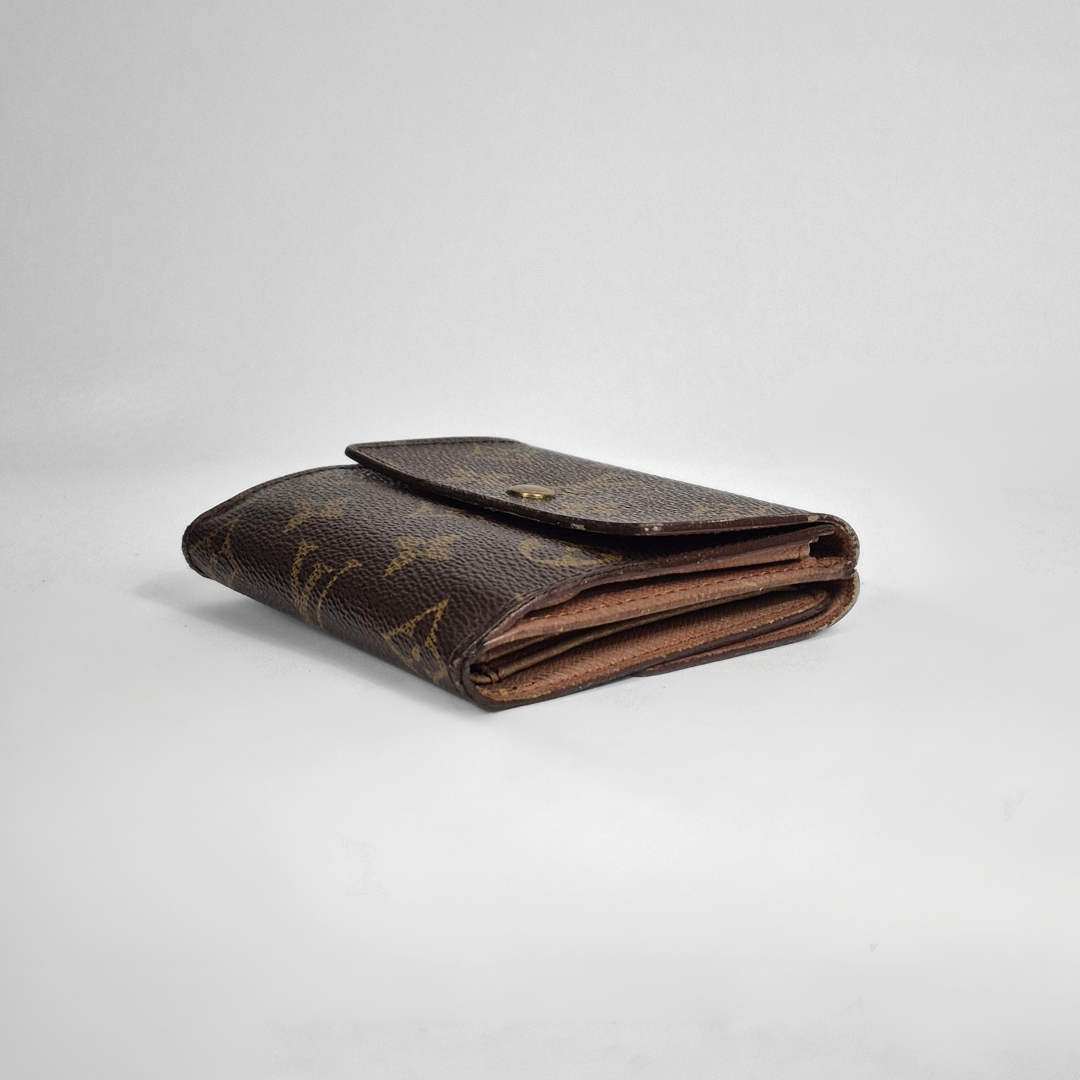 Brown wallet with monogram pattern on a light gray background