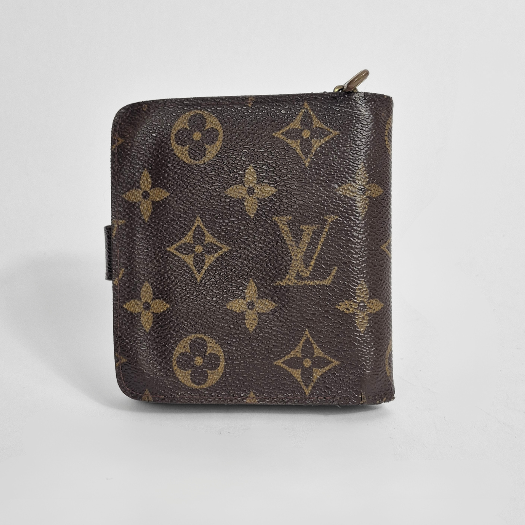 Louis Vuitton wallet with monogram pattern on a light gray background