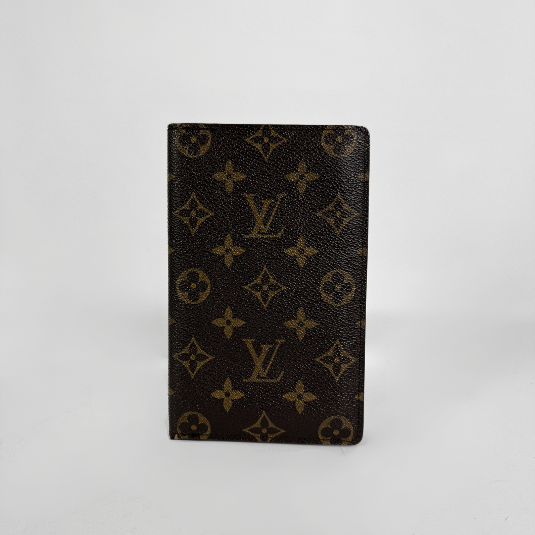 A Louis Vuitton wallet in front a white background