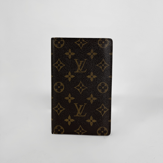 A Louis Vuitton wallet in front a white background