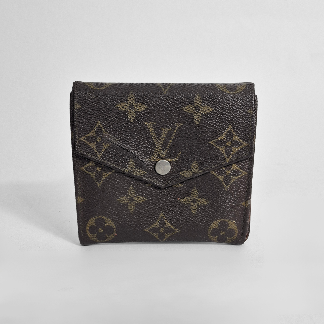 Louis Vuitton wallet with monogram pattern on a white background