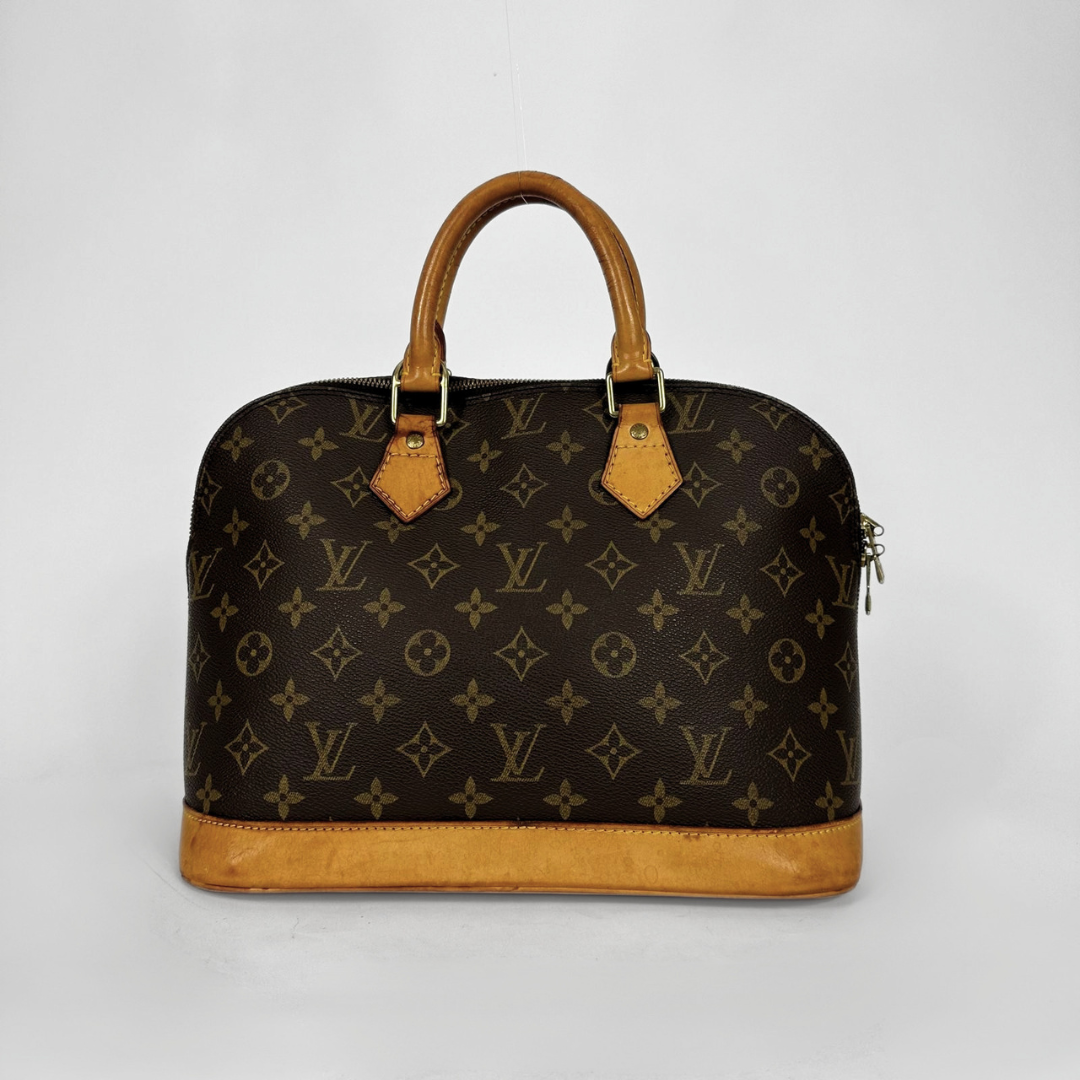 Louis Vuitton monogram canvas dome handbag with tan leather handles and trim, photographed against a light gray studio background.