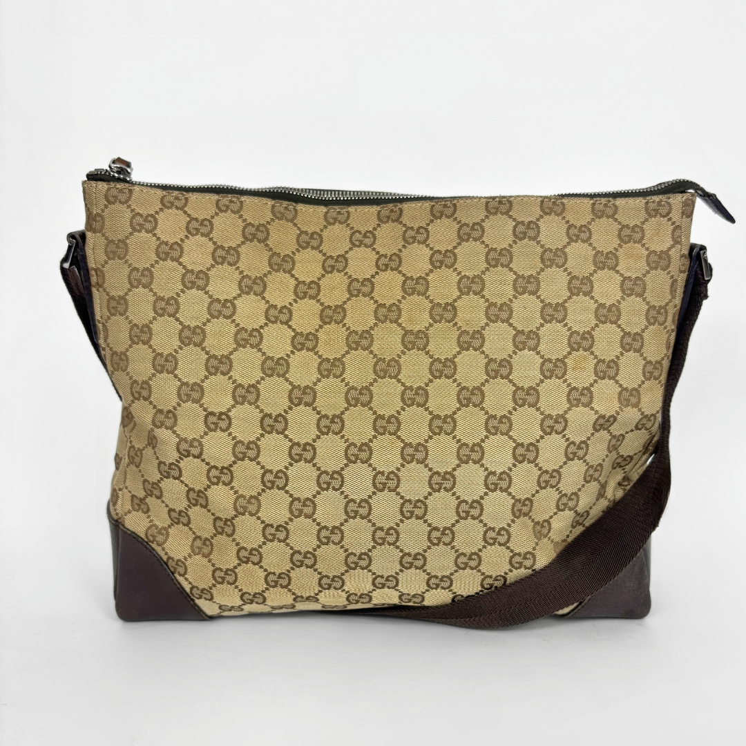 Beige shoulderbag with brown accents and a pattern on a white background