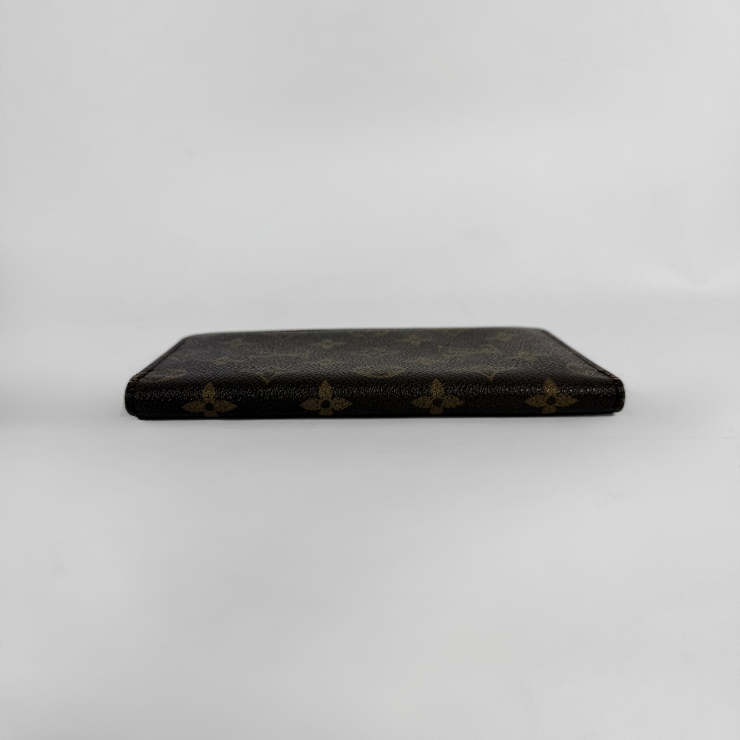 A dark brown Louis Vuitton monogram wallet or card holder shown closed from the front on a plain light gray background.