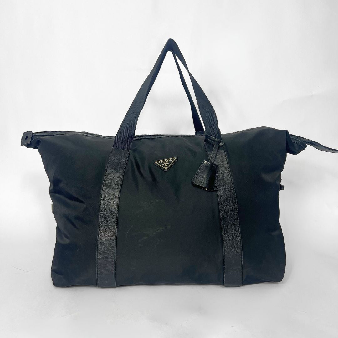 Black duffel bag with Prada logo on a white background