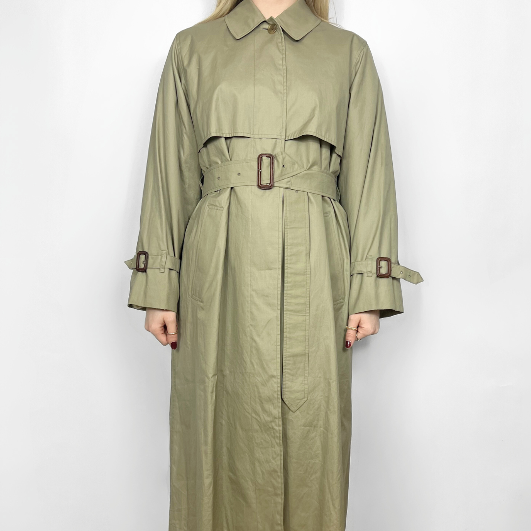 Green trench coat with belt on a white background