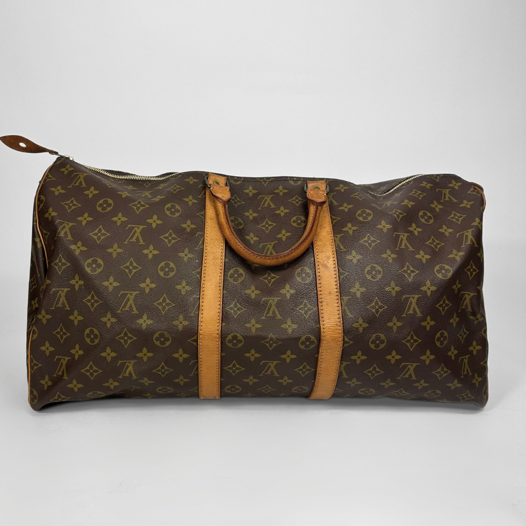 Brown monogram patterned bag with tan leather handles on a white background