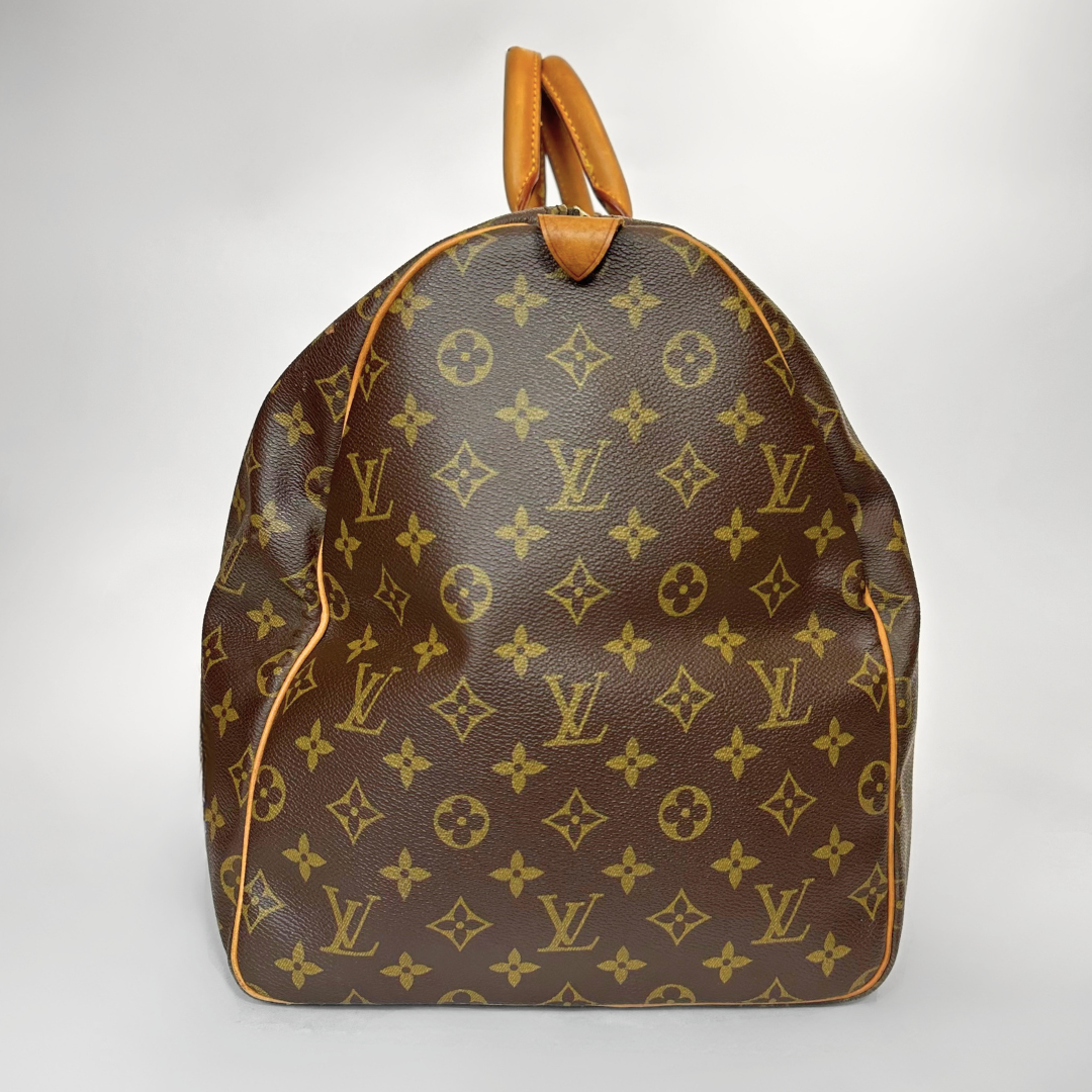 Brown backpack with yellow monogram pattern on a white background