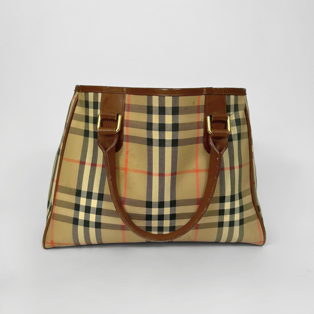 Plaid handbag with brown handles on a white background