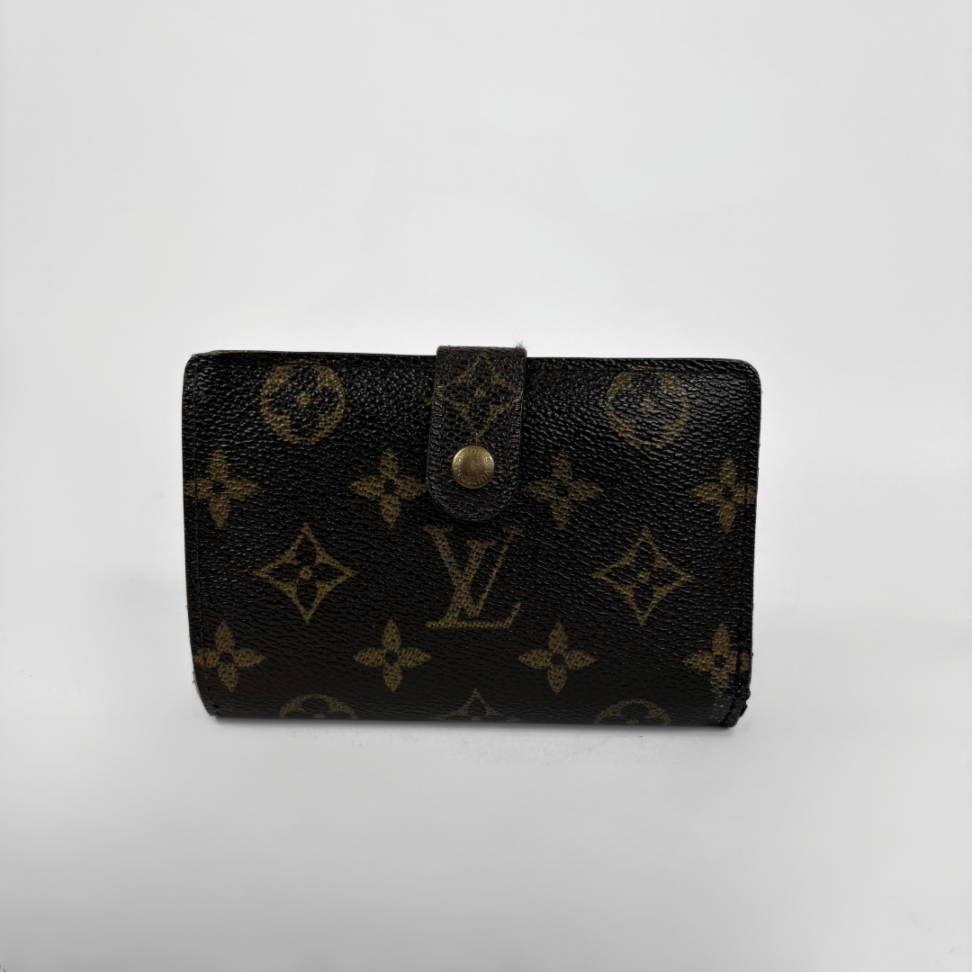 A Louis Vuitton monogram canvas wallet in dark brown with gold-tone hardware, photographed against a plain light gray background.