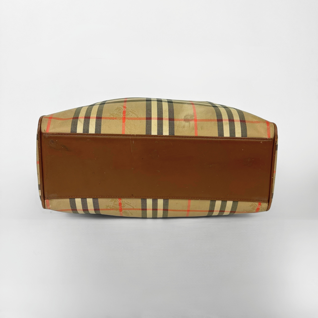 Brown leather clutch with checkered pattern on a white background