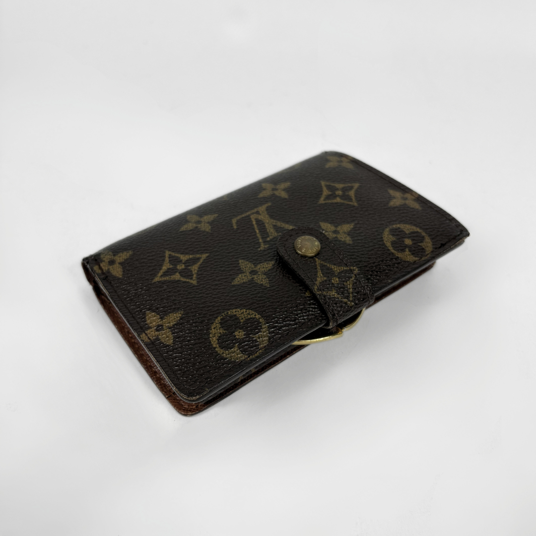 A Louis Vuitton monogram canvas key case in dark brown with gold-tone hardware, photographed on a clean white background.