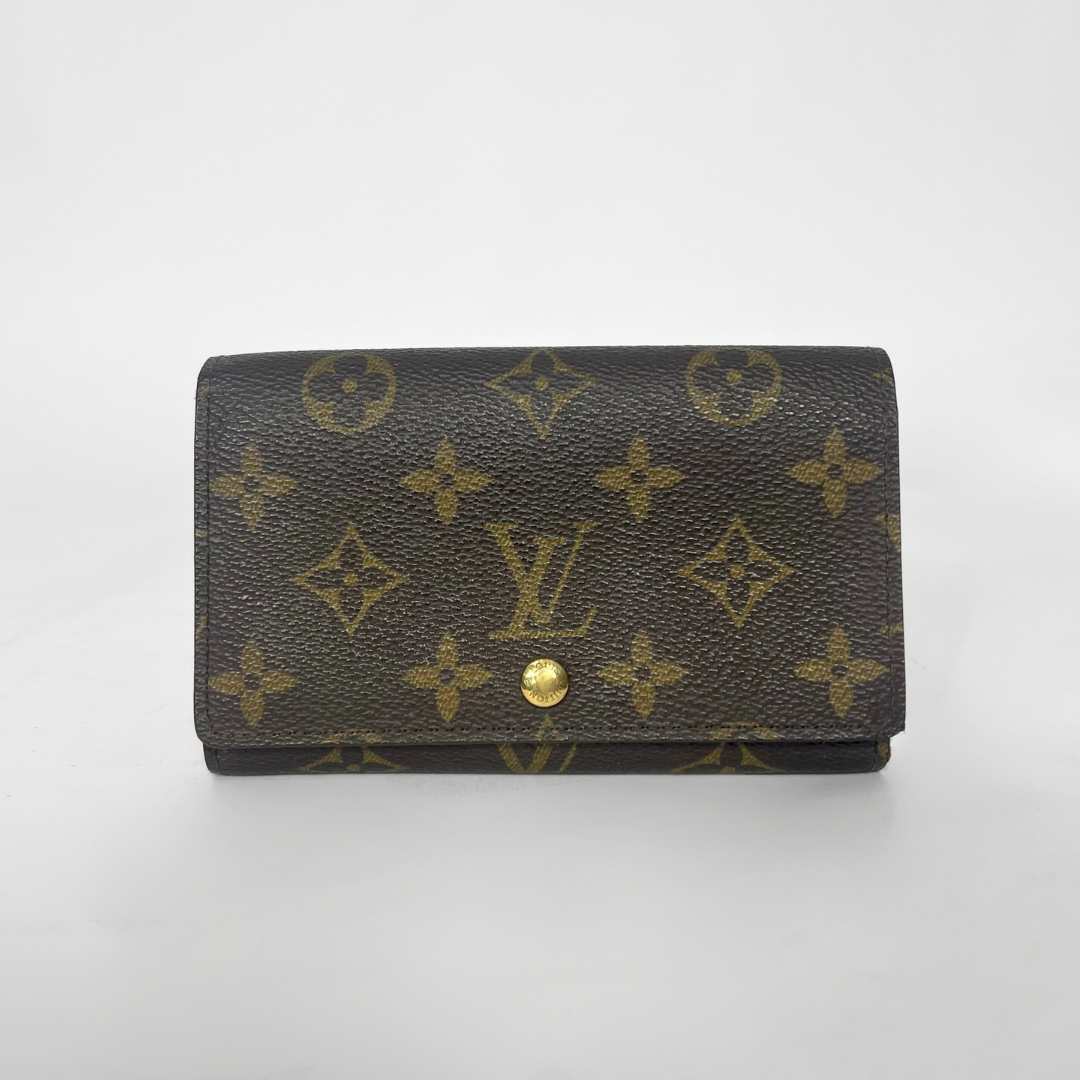Louis Vuitton wallet with monogram pattern on a white background