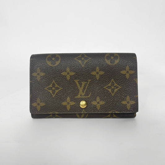 Louis Vuitton wallet with monogram pattern on a white background