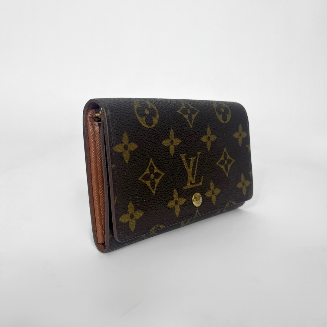 Louis Vuitton wallet with monogram pattern on a white background