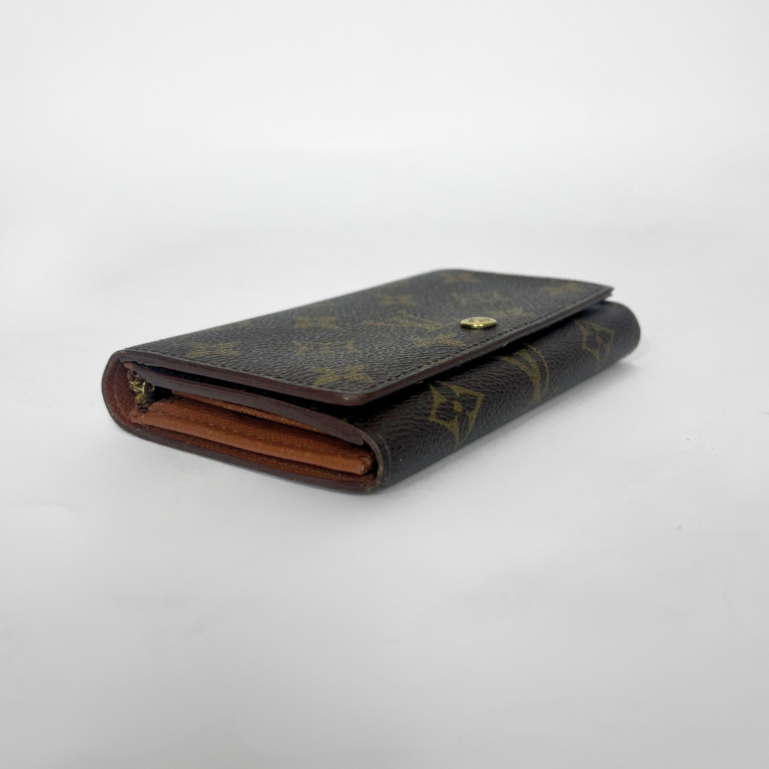 Folded wallet with brown leather interior on a white background