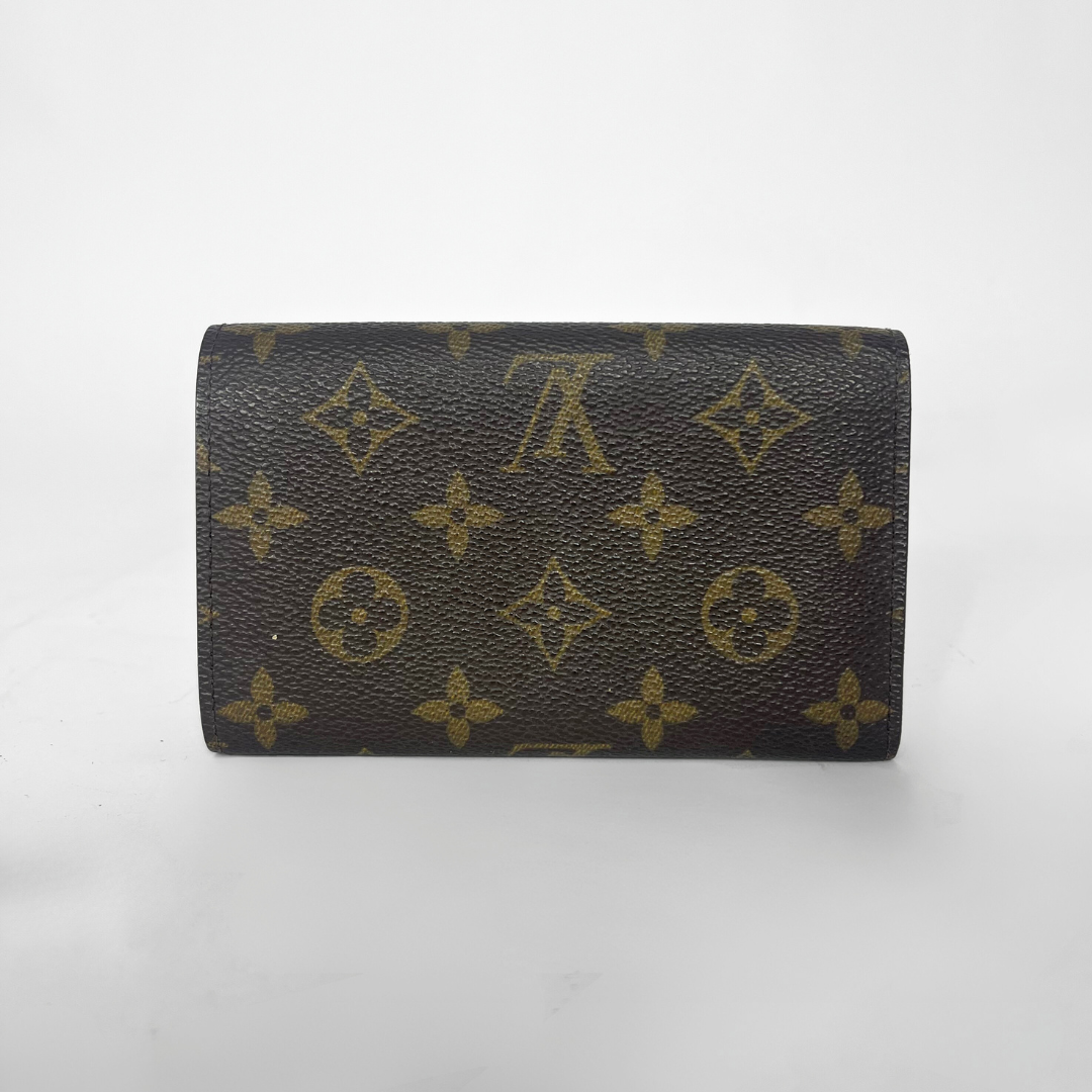 Designer wallet with monogram pattern on a white background