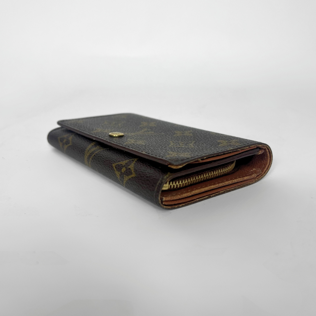 Louis Vuitton wallet with monogram pattern on a white background