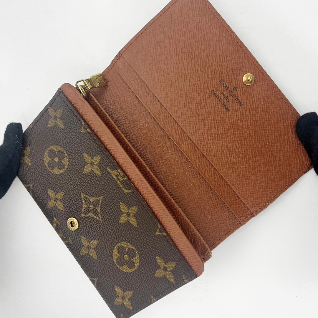 Folded wallet with brown leather interior on a white background