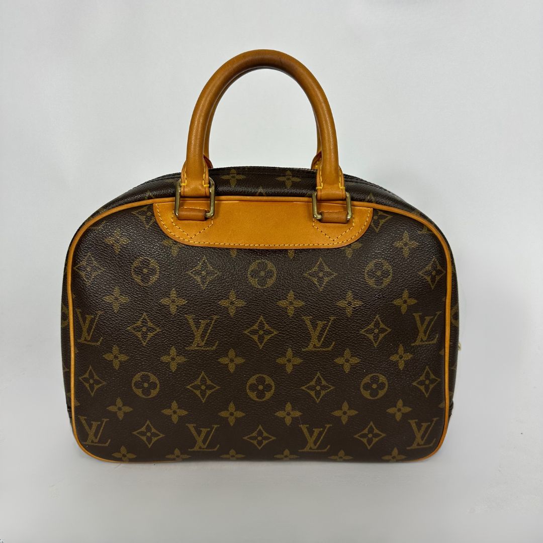 Louis Vuitton monogram canvas handbag with tan leather handles and trim, photographed against a plain light background.