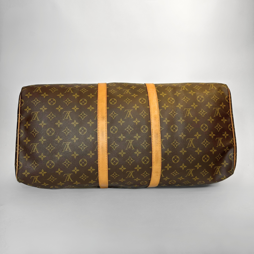 Brown patterned travel bag with orange straps on a light gray background