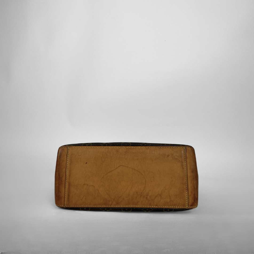 A tan leather clutch or wallet with a distressed, worn finish and visible scuffs, photographed against a neutral light gray background.