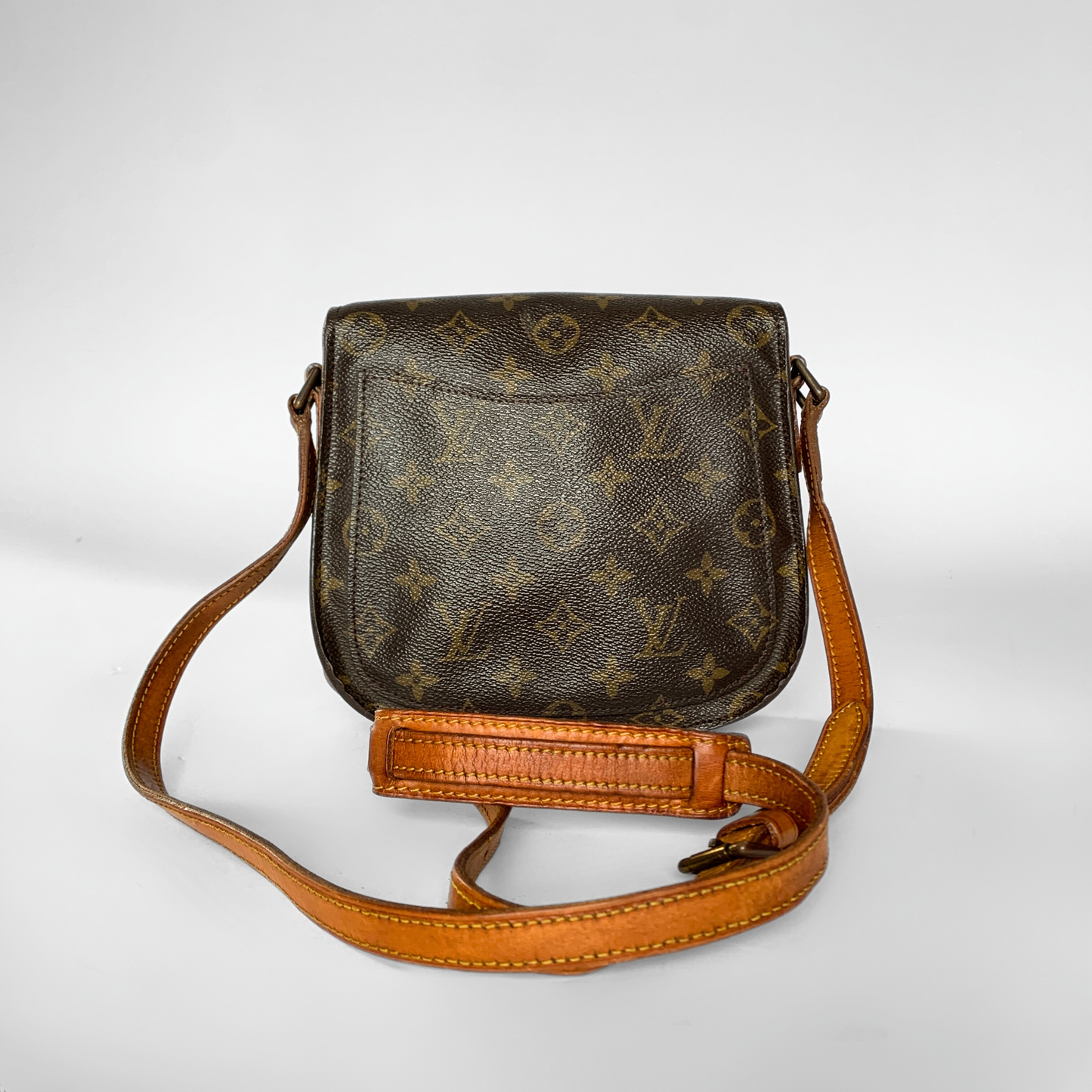 Brown leather handbag with monogram pattern on a white background