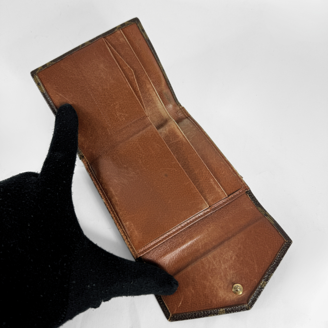 Louis Vuitton Druk Wallet on a white background