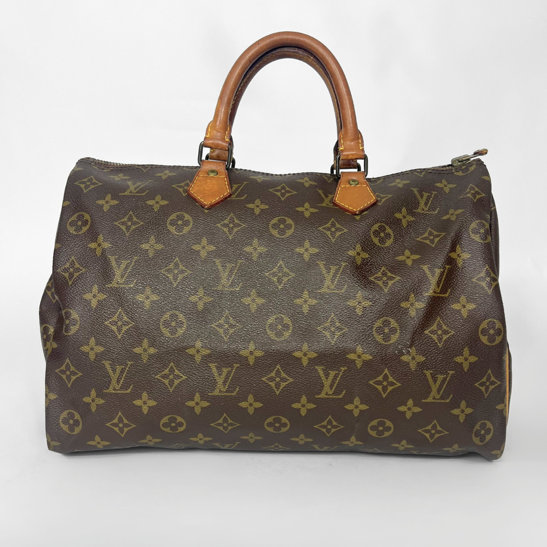 Brown handbag with monogram pattern on a white background