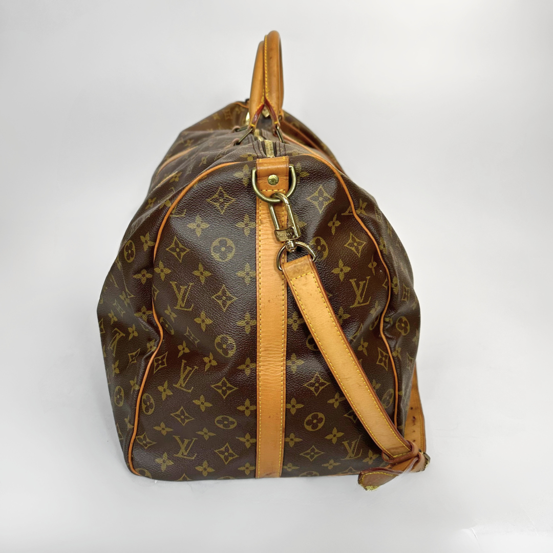 Brown monogram handbag with tan leather accents on a white background