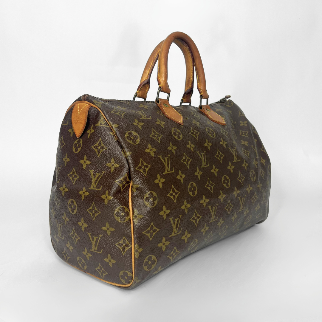 Brown leather handbag with visible brand logo on a white background