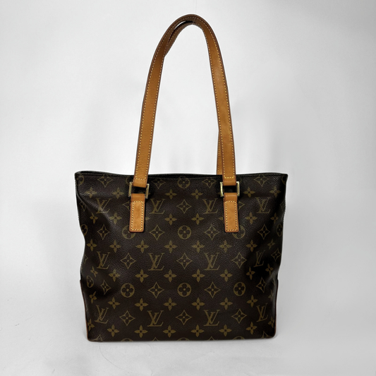 Louis Vuitton monogram canvas tote bag with tan leather shoulder straps and gold-tone hardware, photographed against a plain light gray background.
