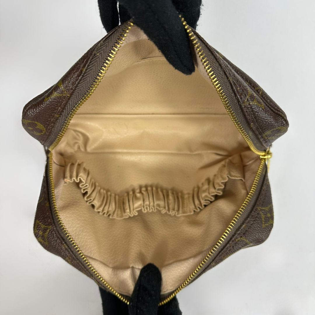 Louis Vuitton toiletry bag in front of white background