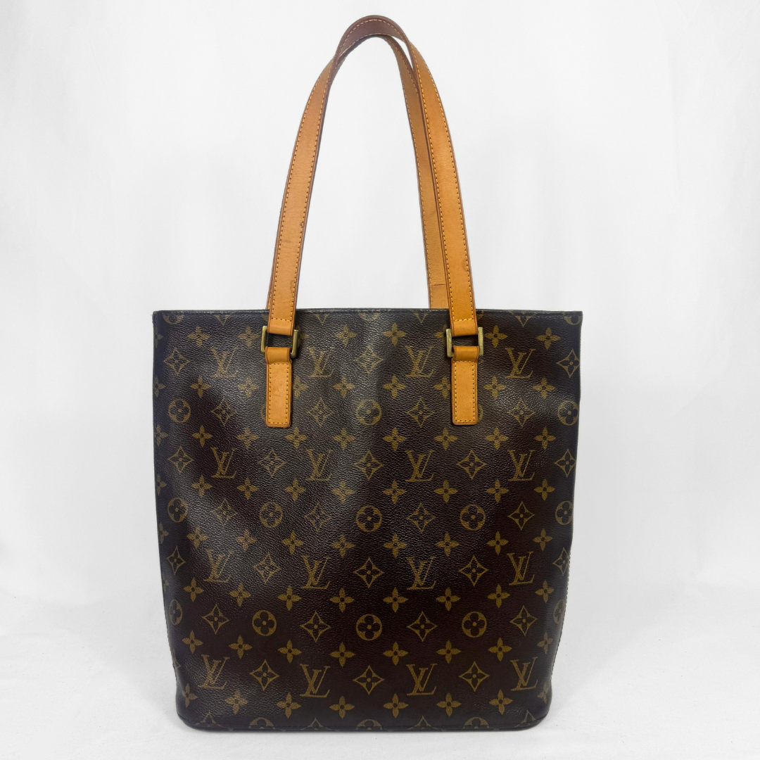 A Louis Vuitton monogram canvas bag with dark brown and tan leather handles, photographed against a plain white background.