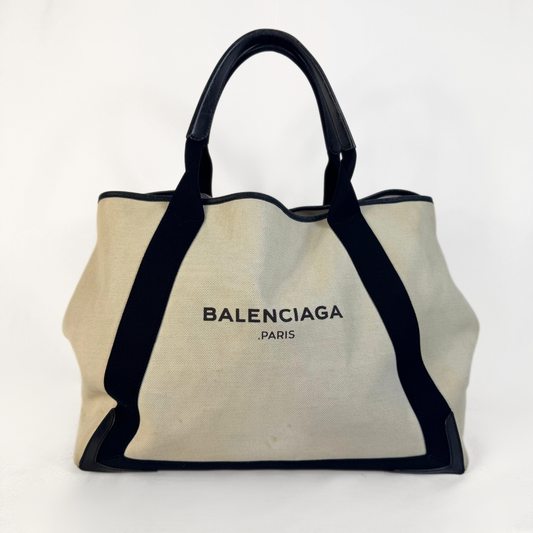 Balenciaga tote bag with black accents on a light gray background