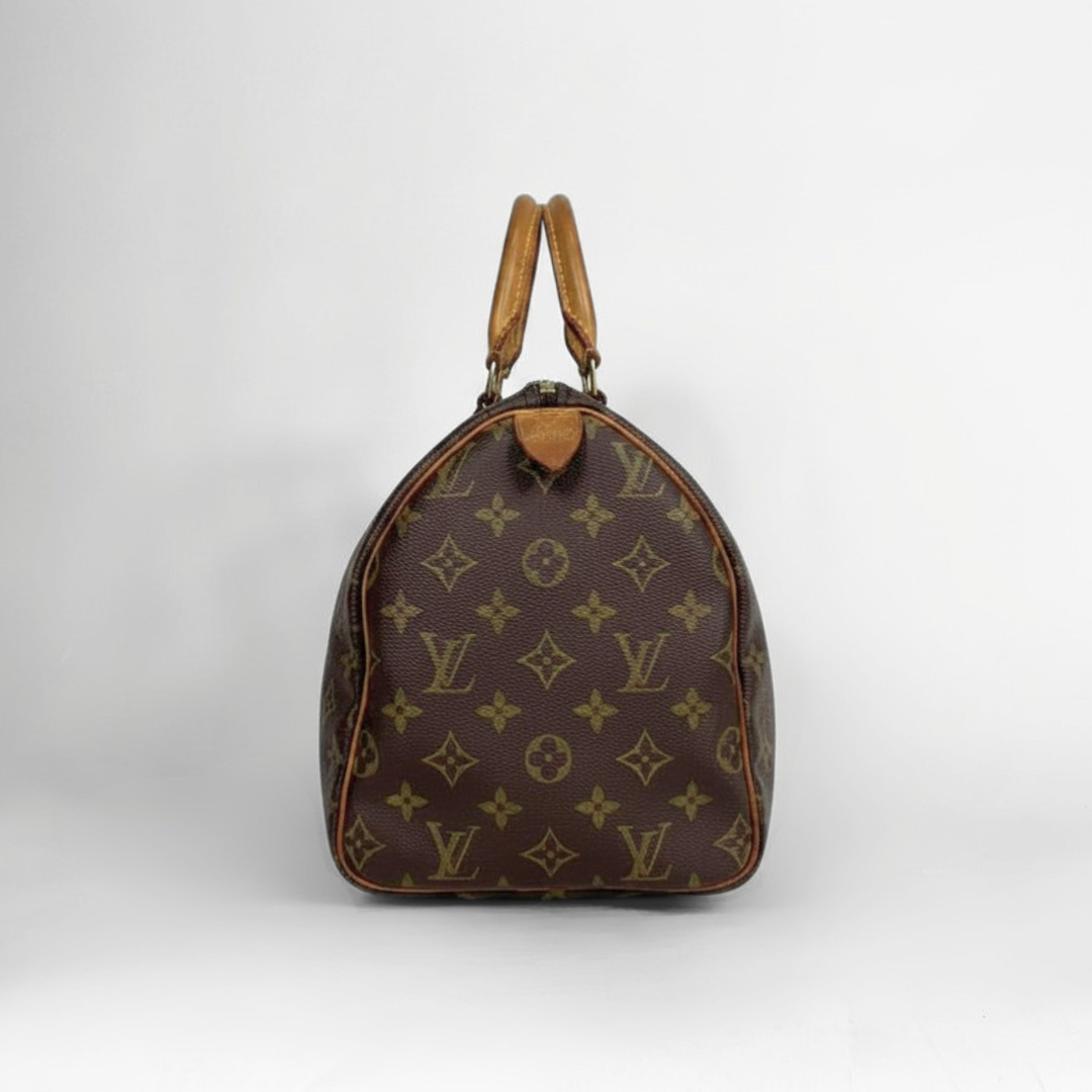 A Louis Vuitton monogram canvas Speedy bag in dark brown with tan leather handles, photographed against a neutral light gray background.