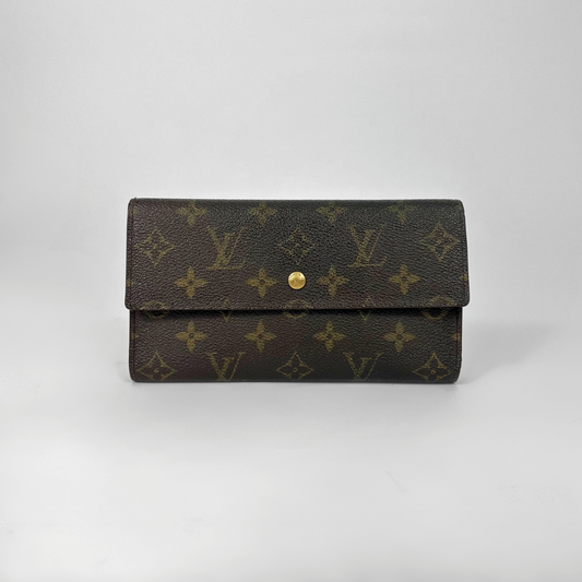 Brown wallet with gold monogram pattern on a light gray background