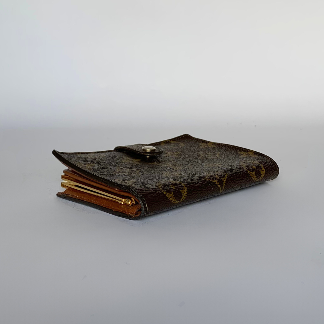 A brown monogram wallet with a snap-button closure, photographed on a plain light gray background.