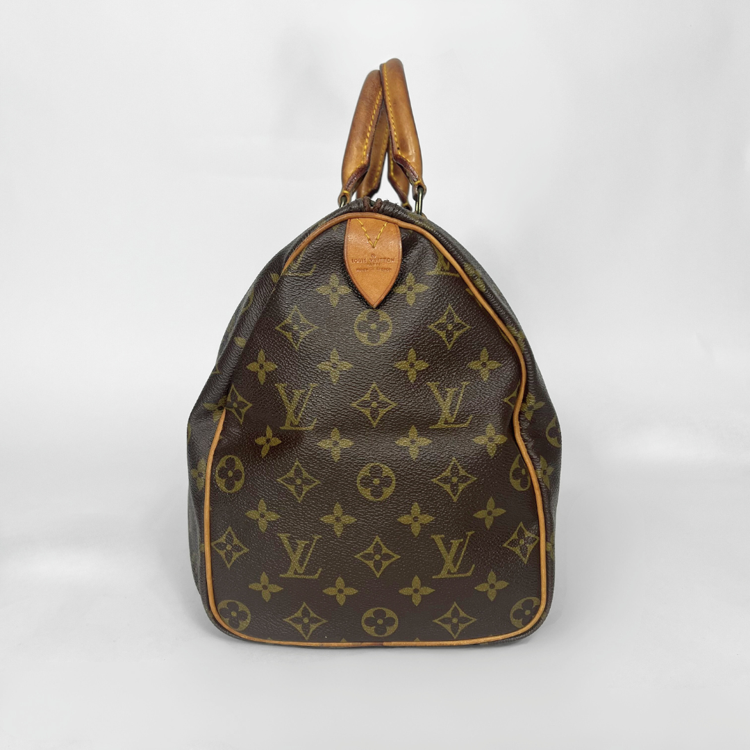 Brown handbag with monogram pattern on a white background